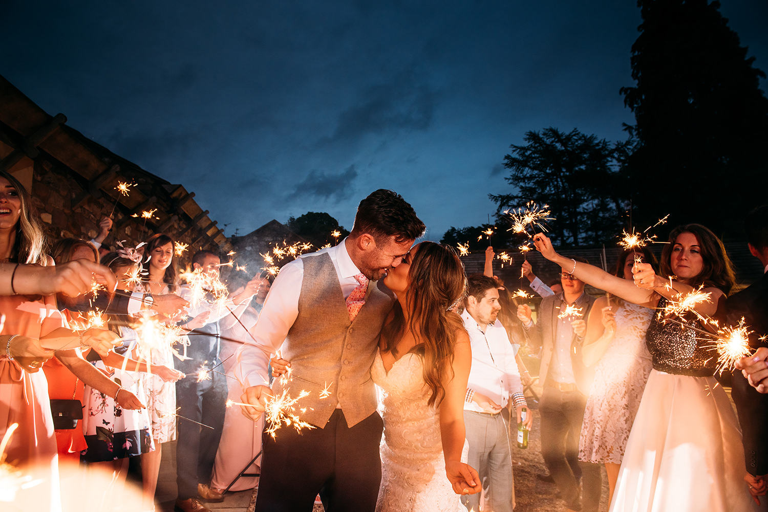 couple and friends with sparklers