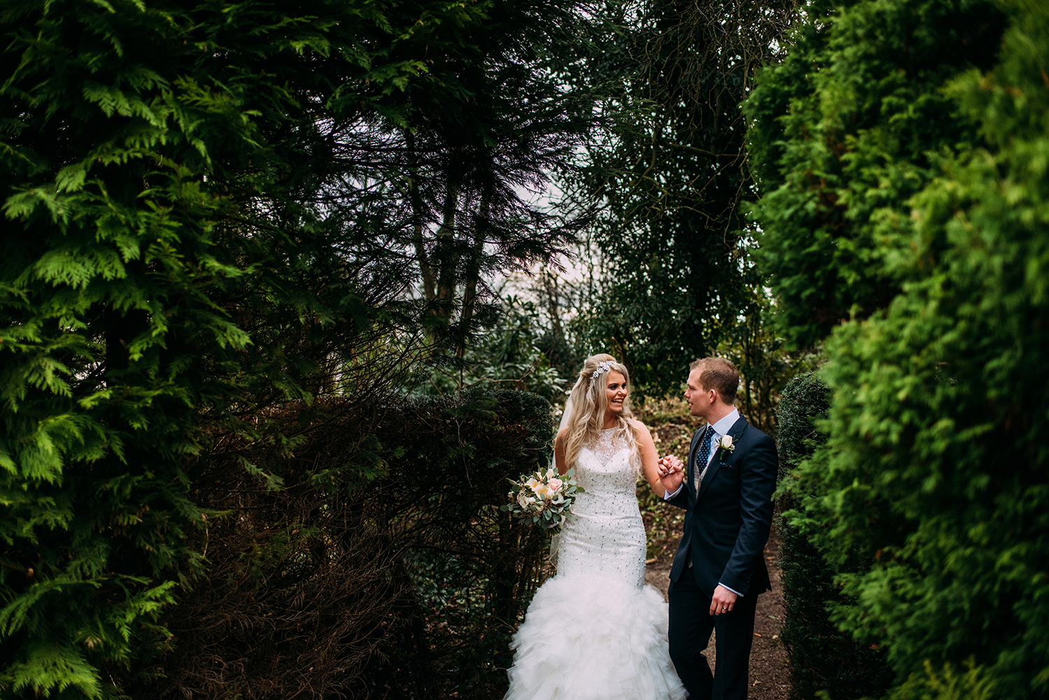 Bride and groom walking through the grounds