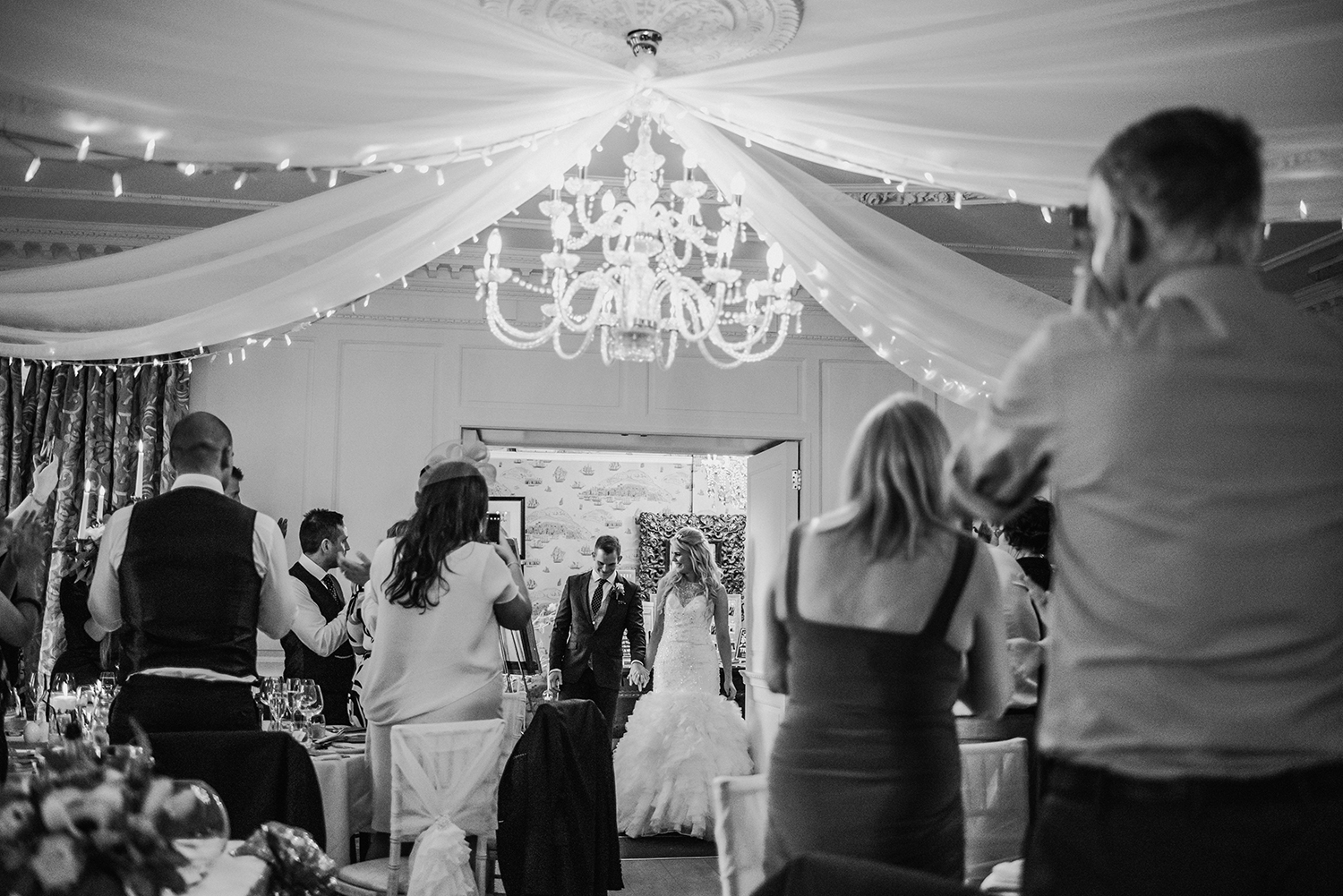 Bride and groom enter wedding breakfast