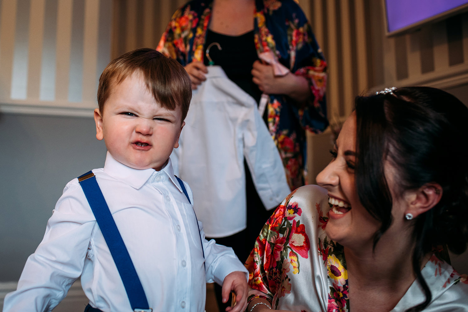 Bride and groom's son pulling his face at the camera