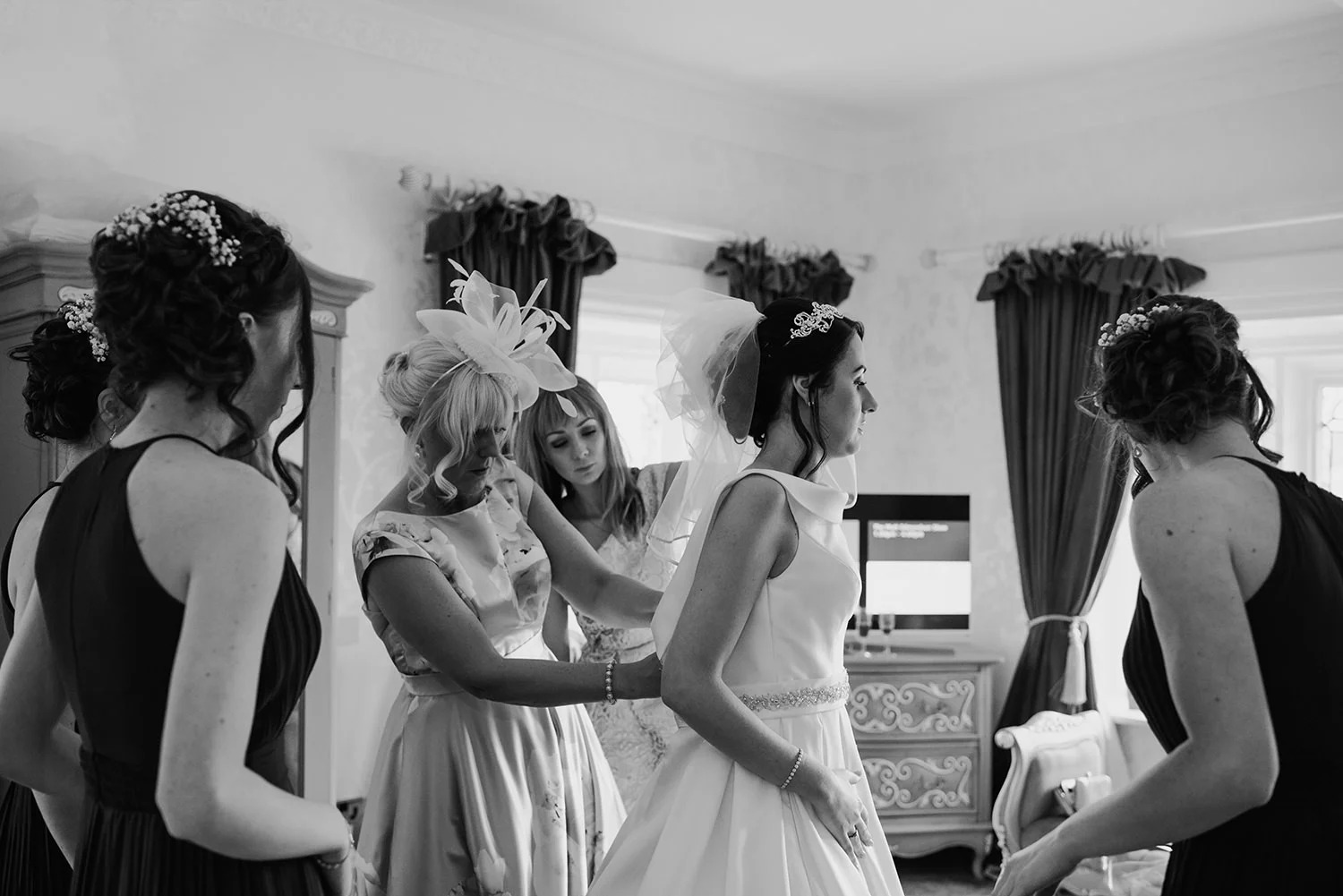  bride dress being fastened up 