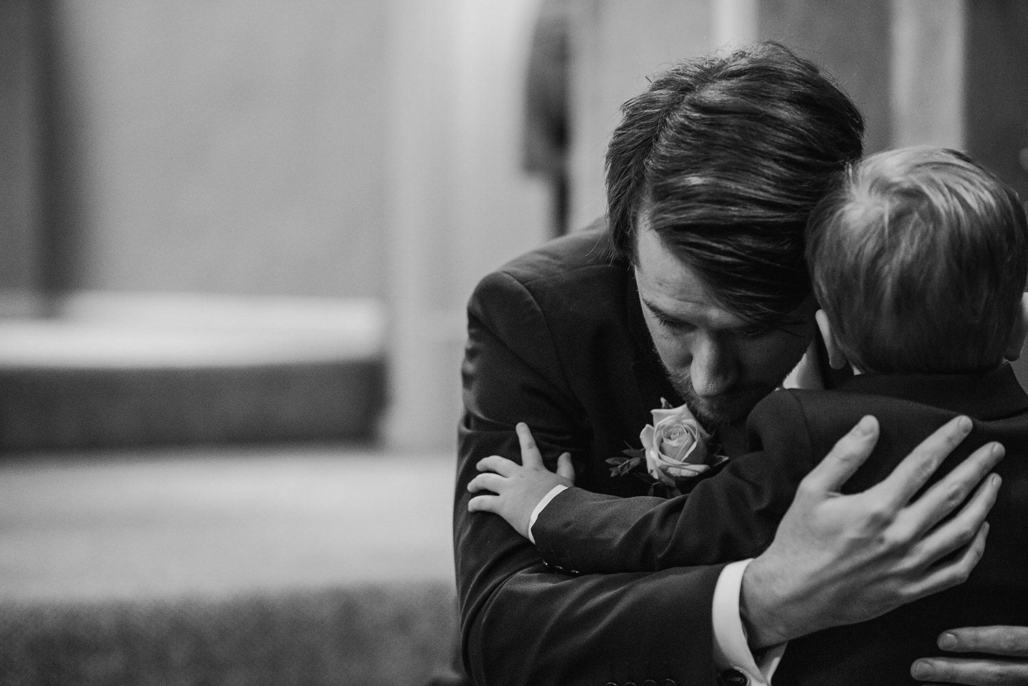 groom hugging his son