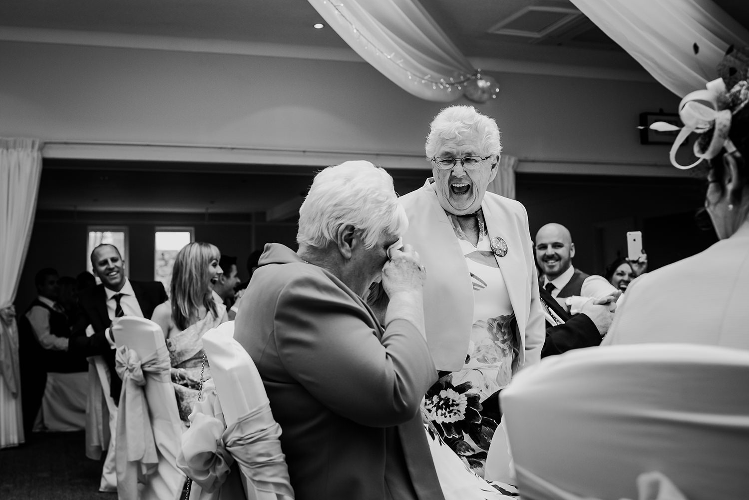  grandma standing up laughing during the wedding breakfast 