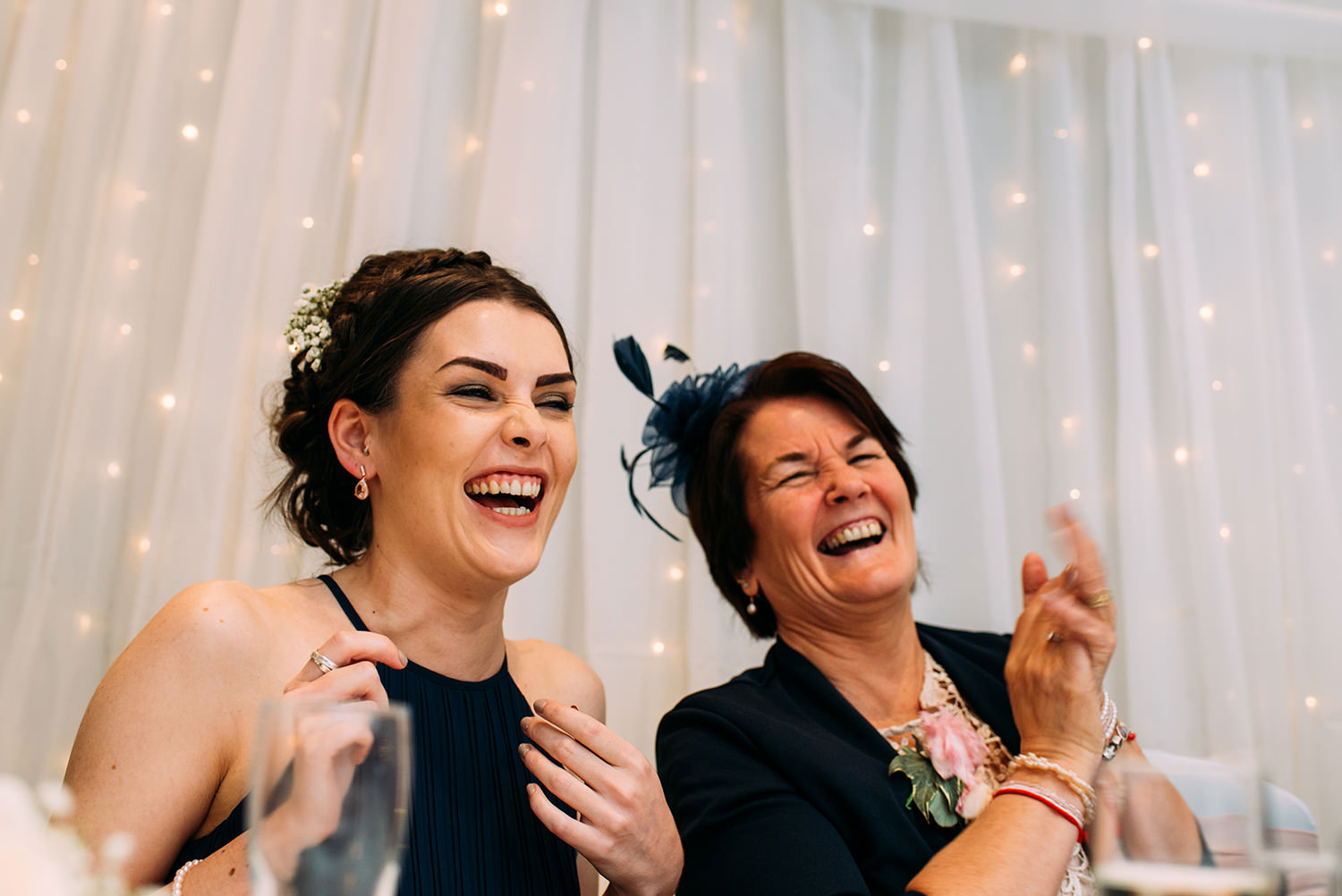 mother and sister of the groom laughing