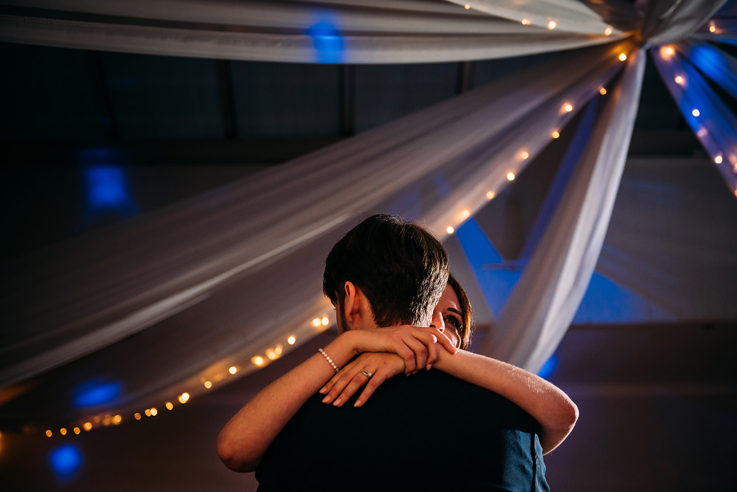 close up photo of couple embracing during first dance