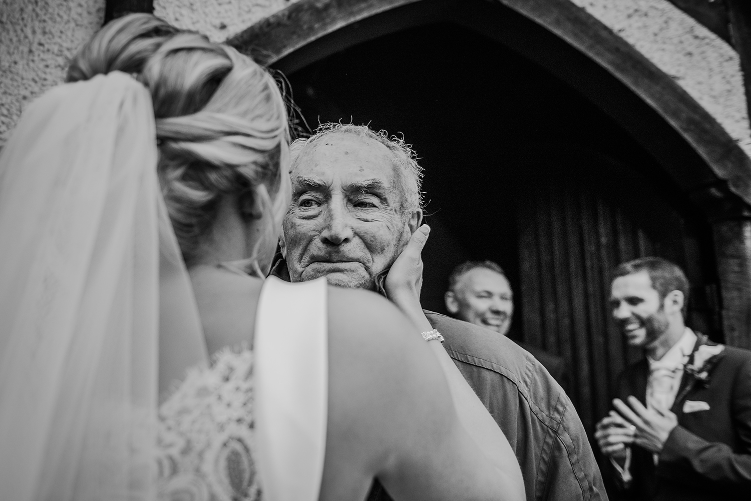  emotional black and white photo of the bride touching her grandfathers face 