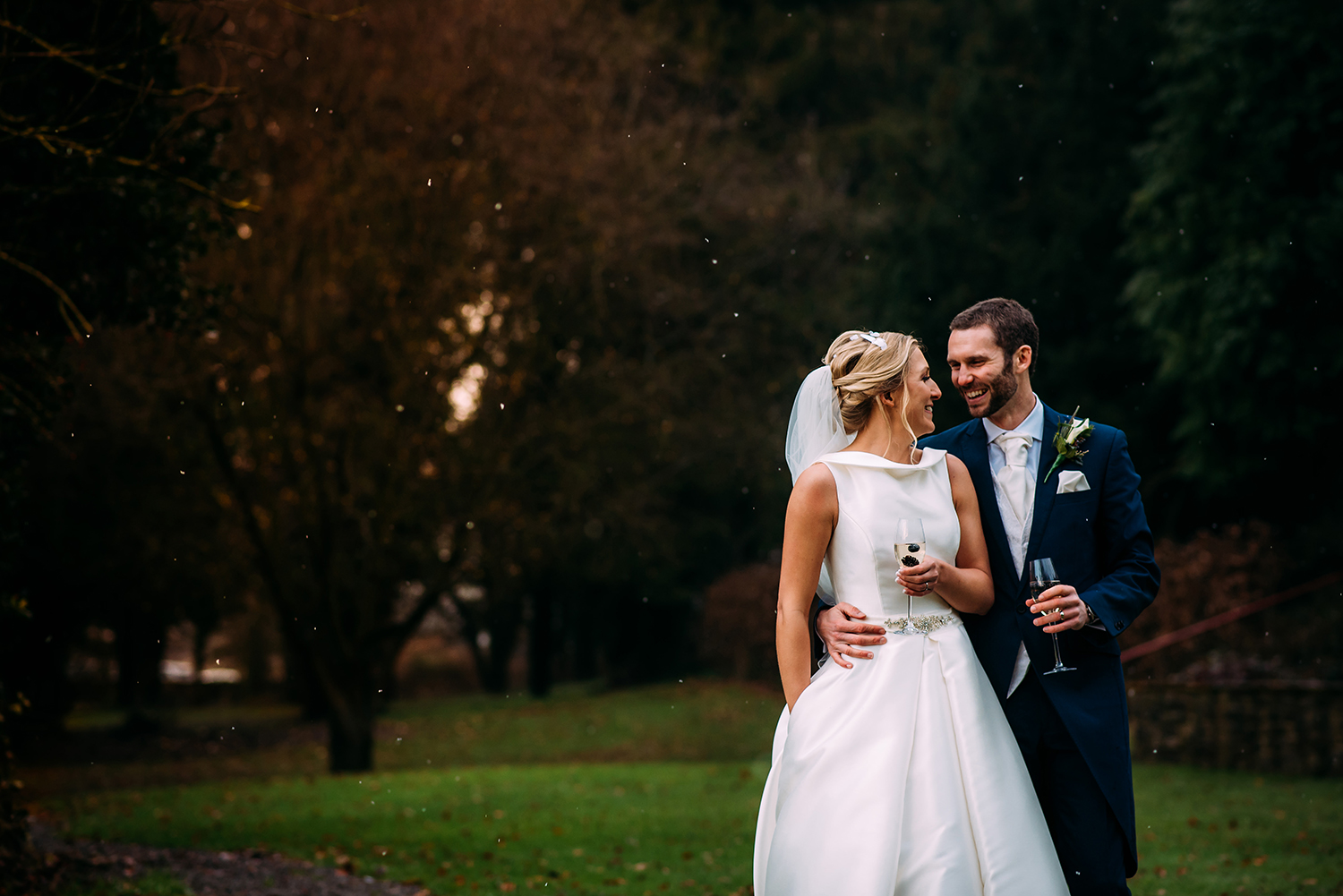  Bride and groom laugh in the grounds at Mitton hall 