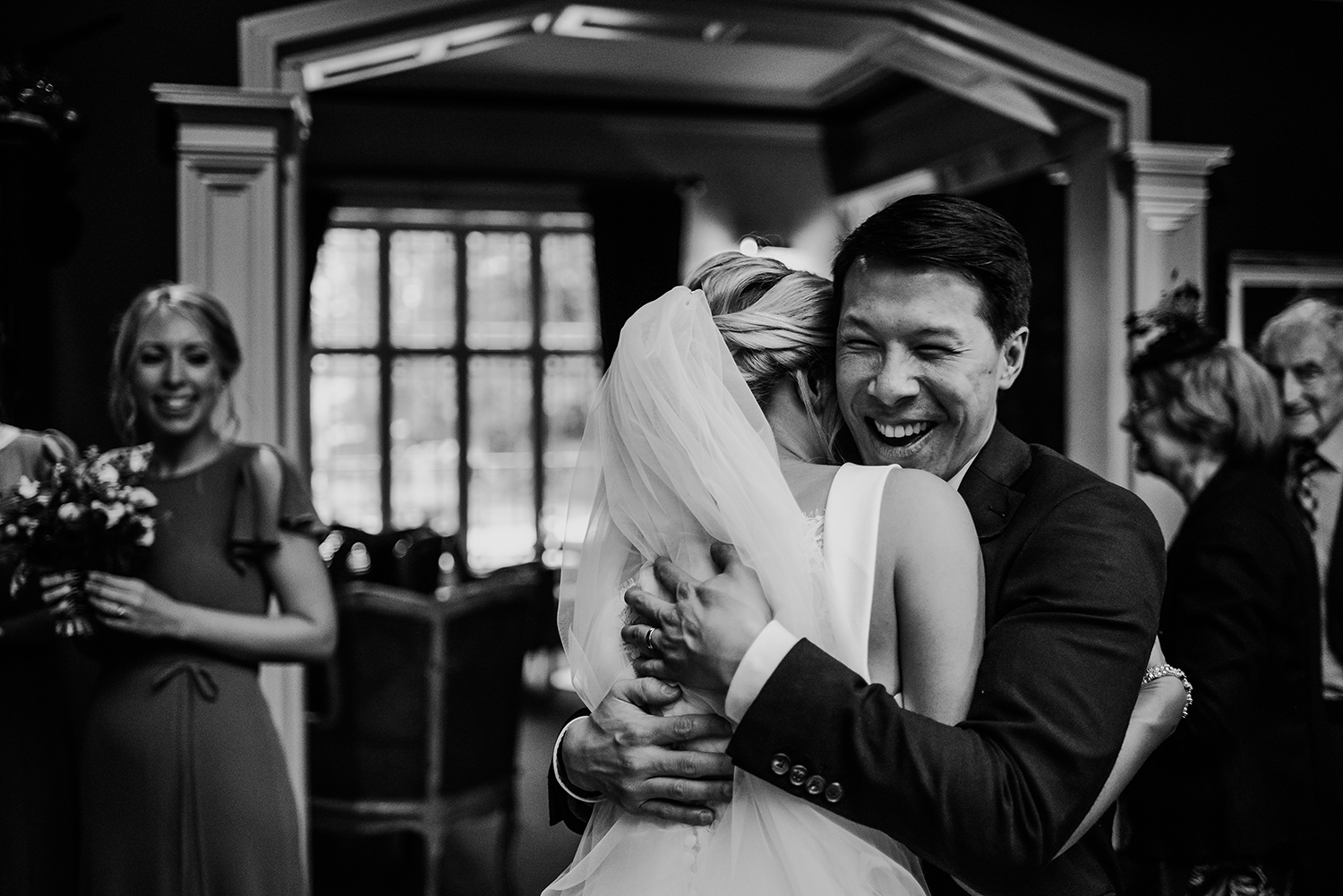  BW photo of guests hugging 