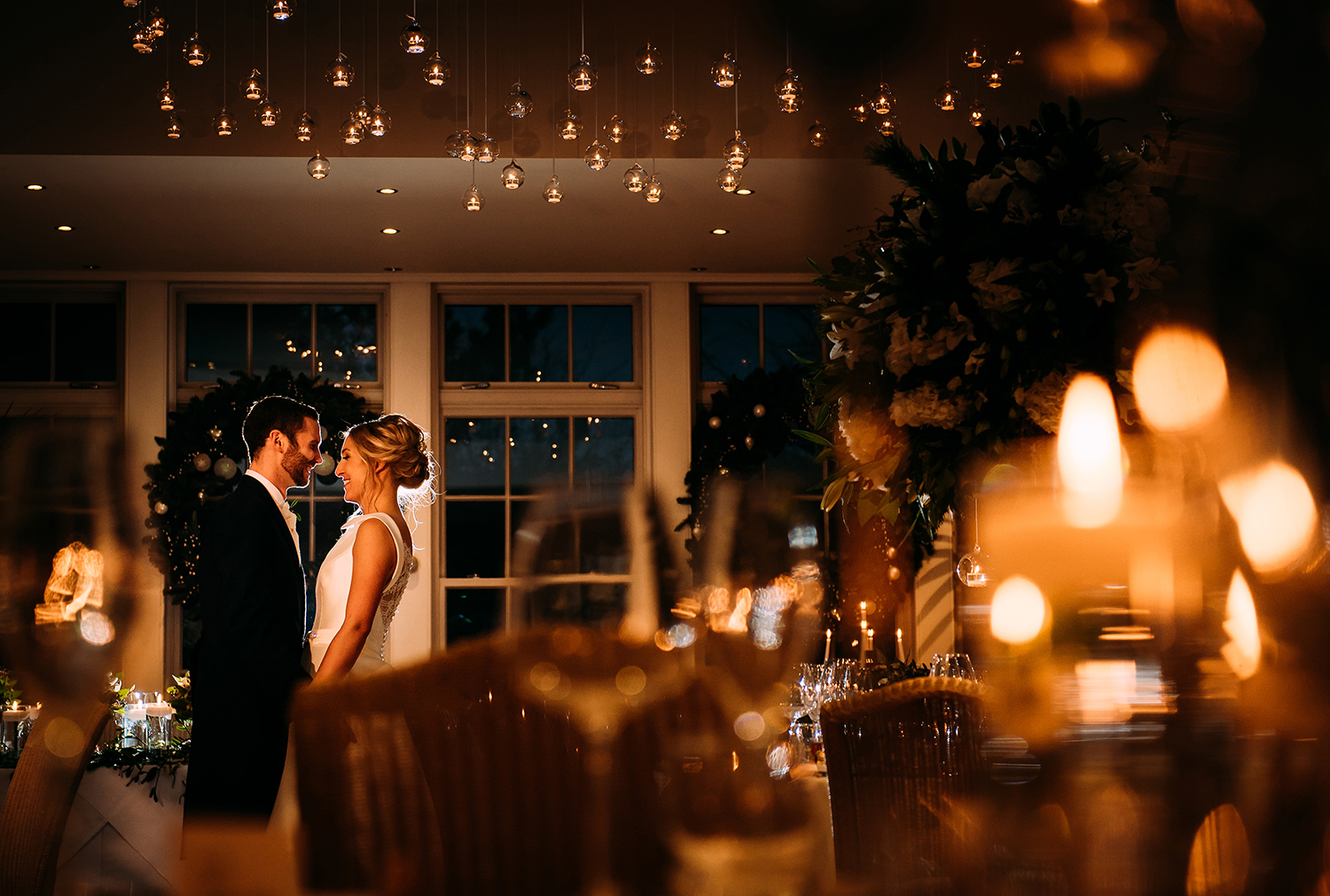  bride and groom in the candle lit reception room 