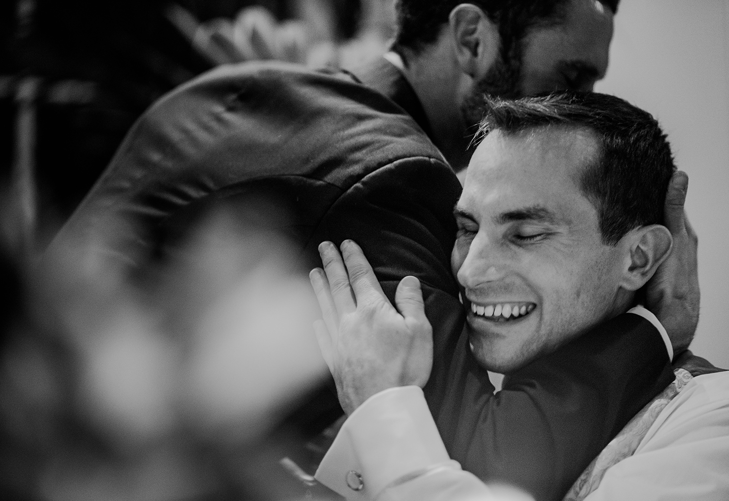  BW photo of groom hugging his brother 