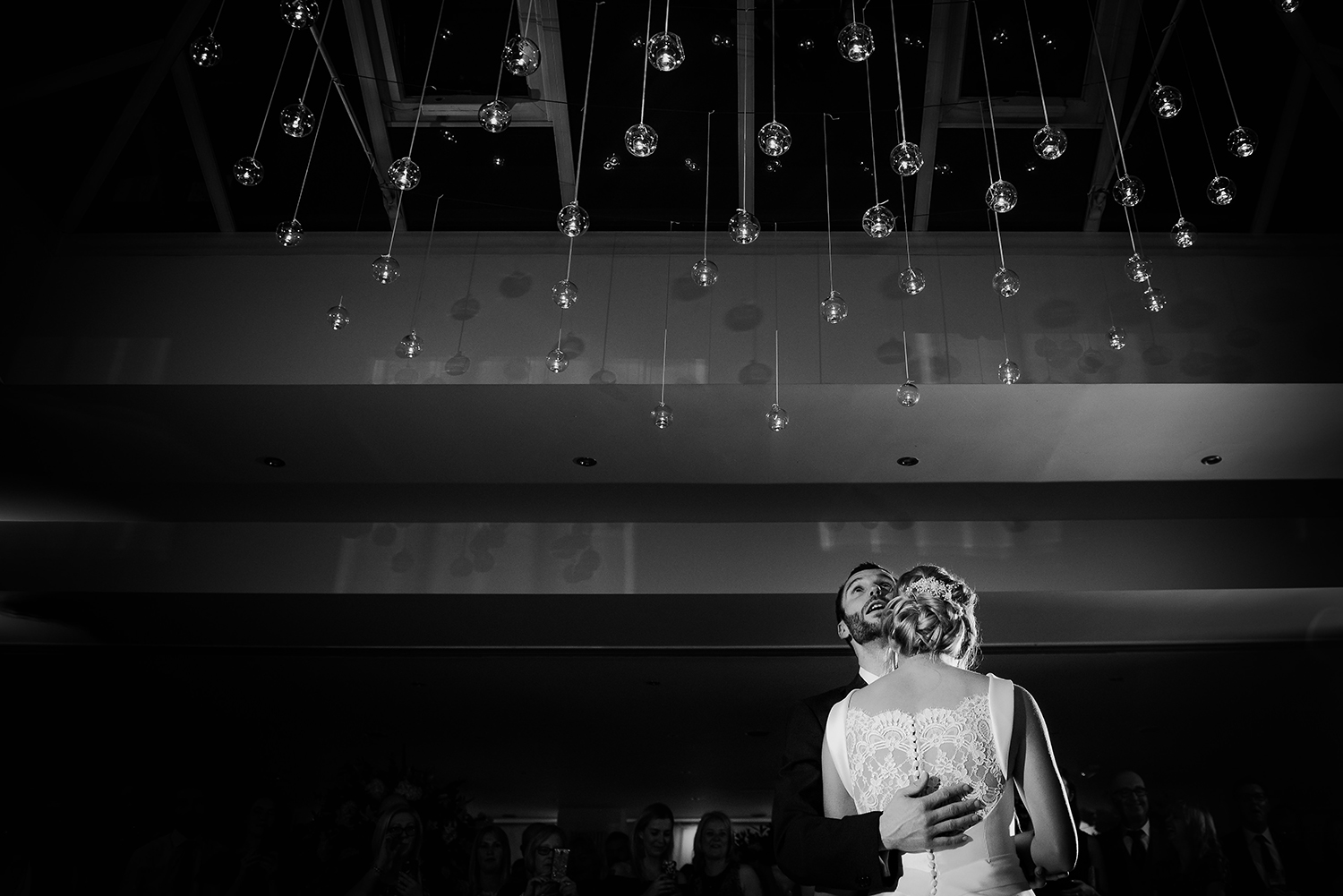  groom looks up at the sky during the first dance. BW photo 