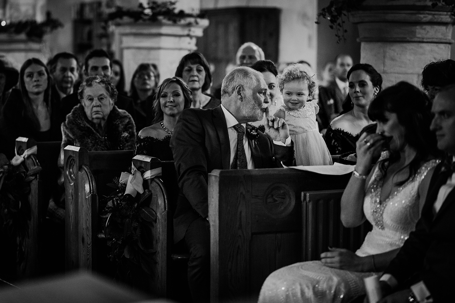 bride and grooms daughter getting told to be quiet by grandad. BW photo