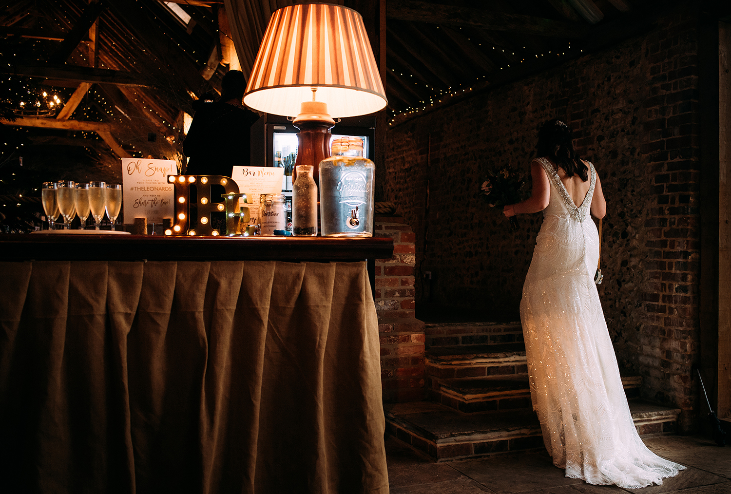 bride walking up steps past window lights