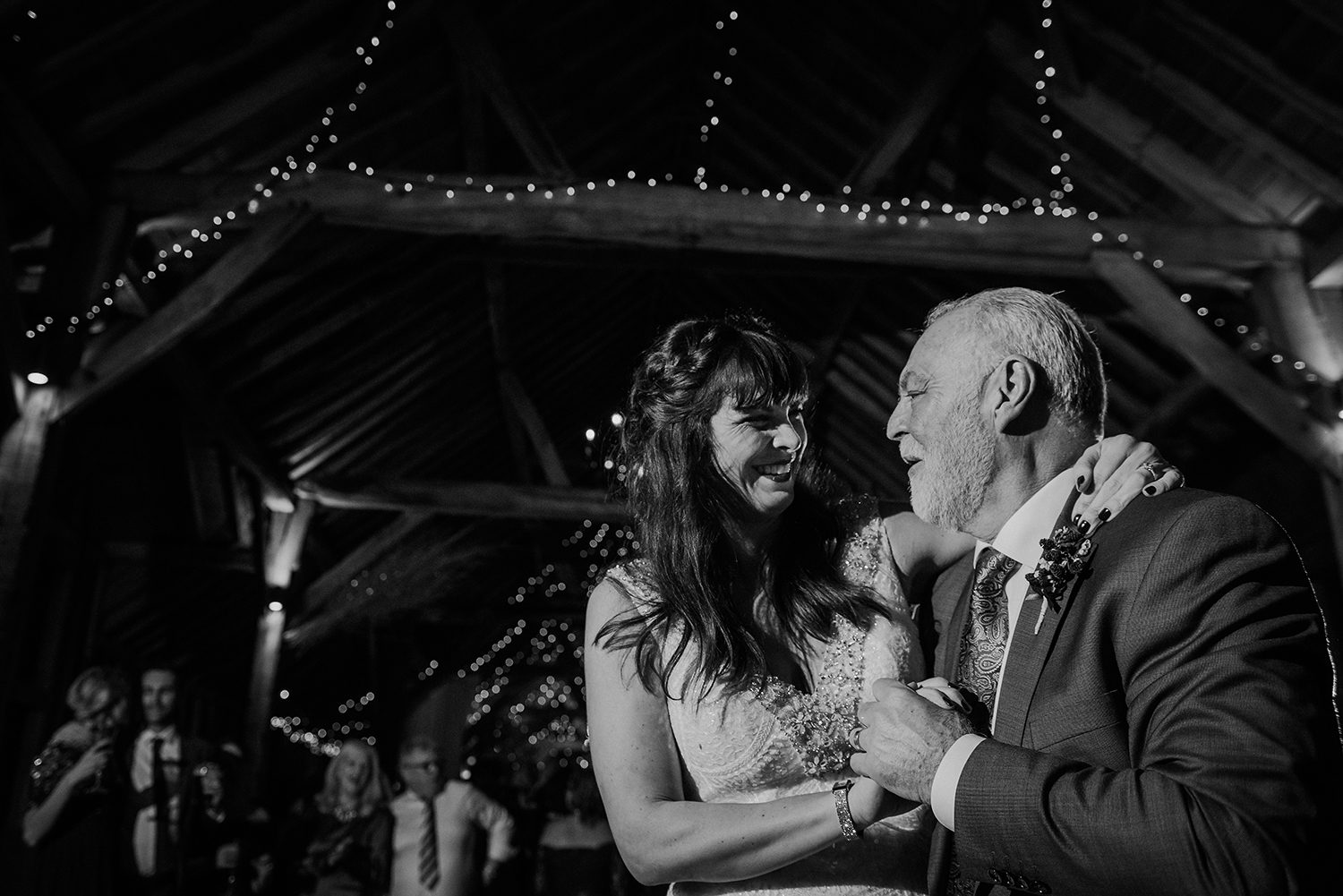 BW photo of bride dancing with father