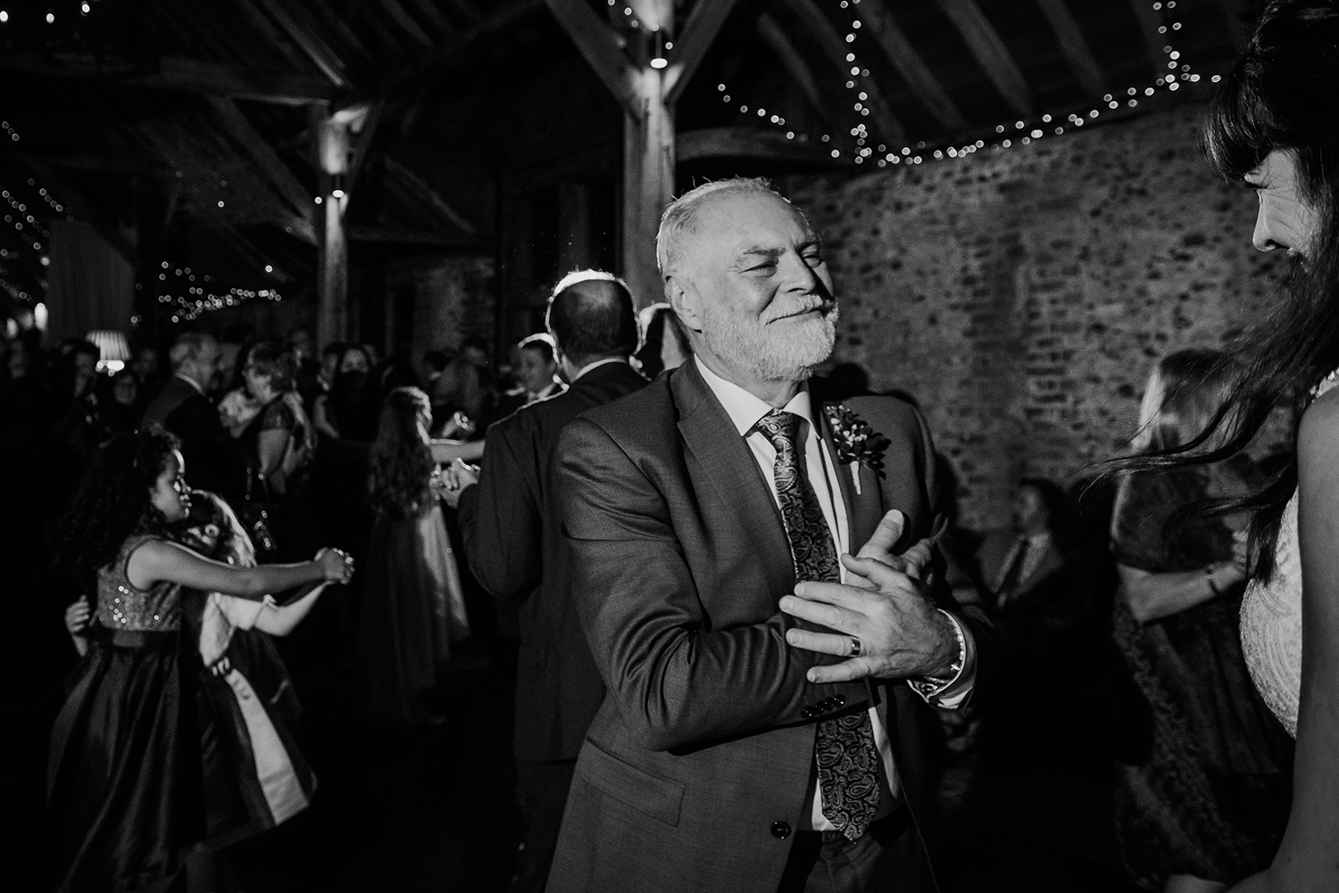 BW photo of dad giving a loving gesture to his daughter
