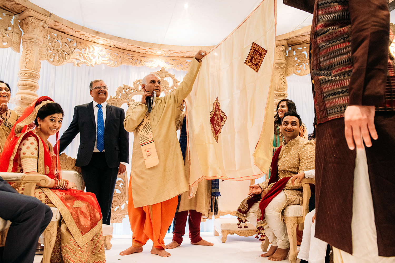  bride and groom separated by a large sheet 