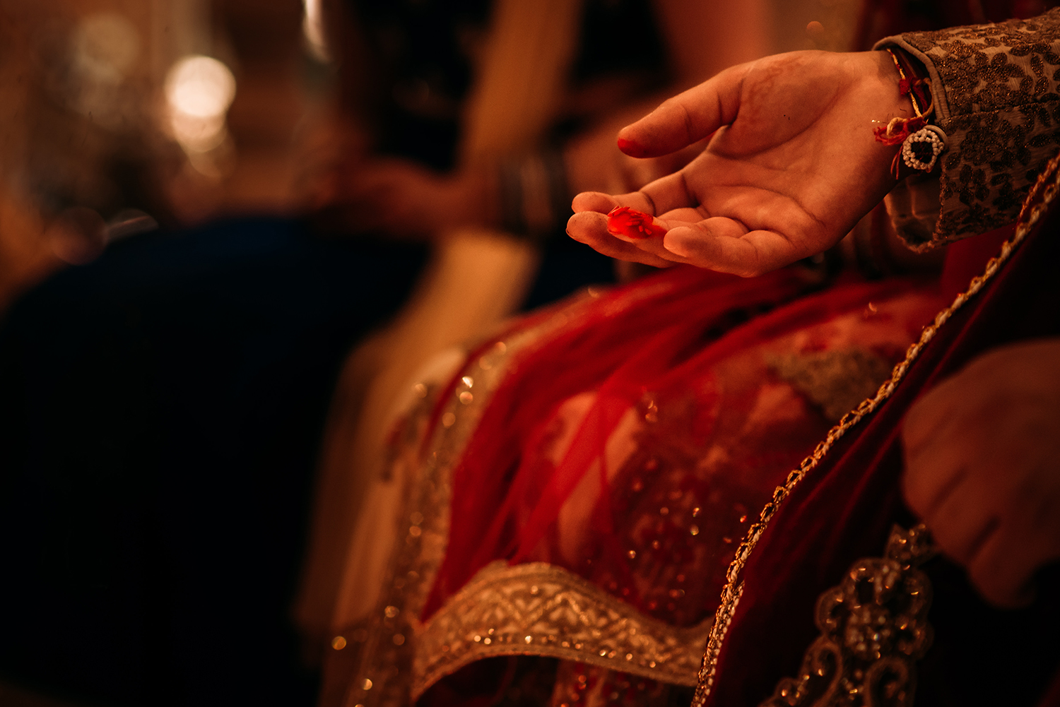  close up of hand with red powder on the finger 