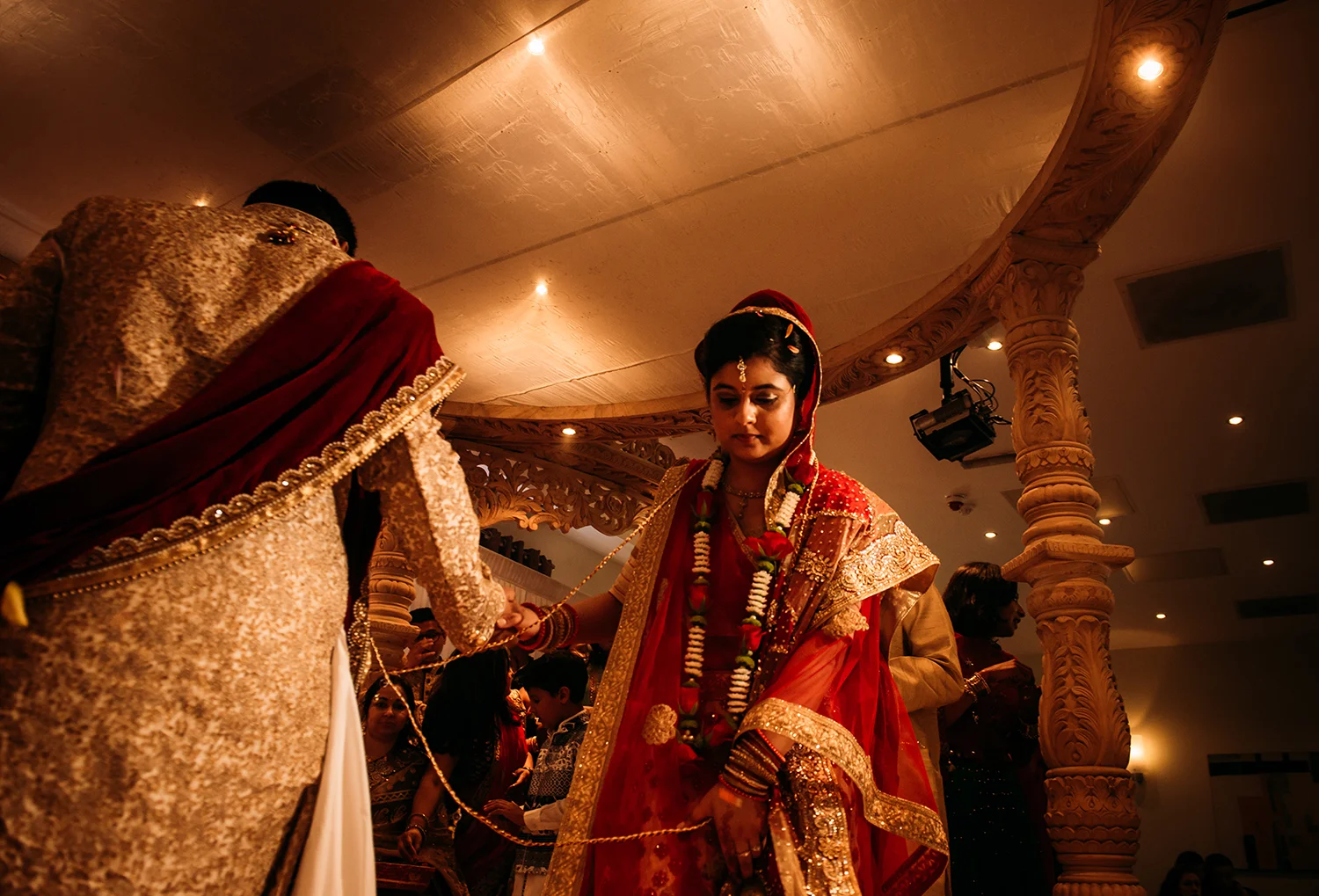 bride and groom circle the stage while petals are thrown over them