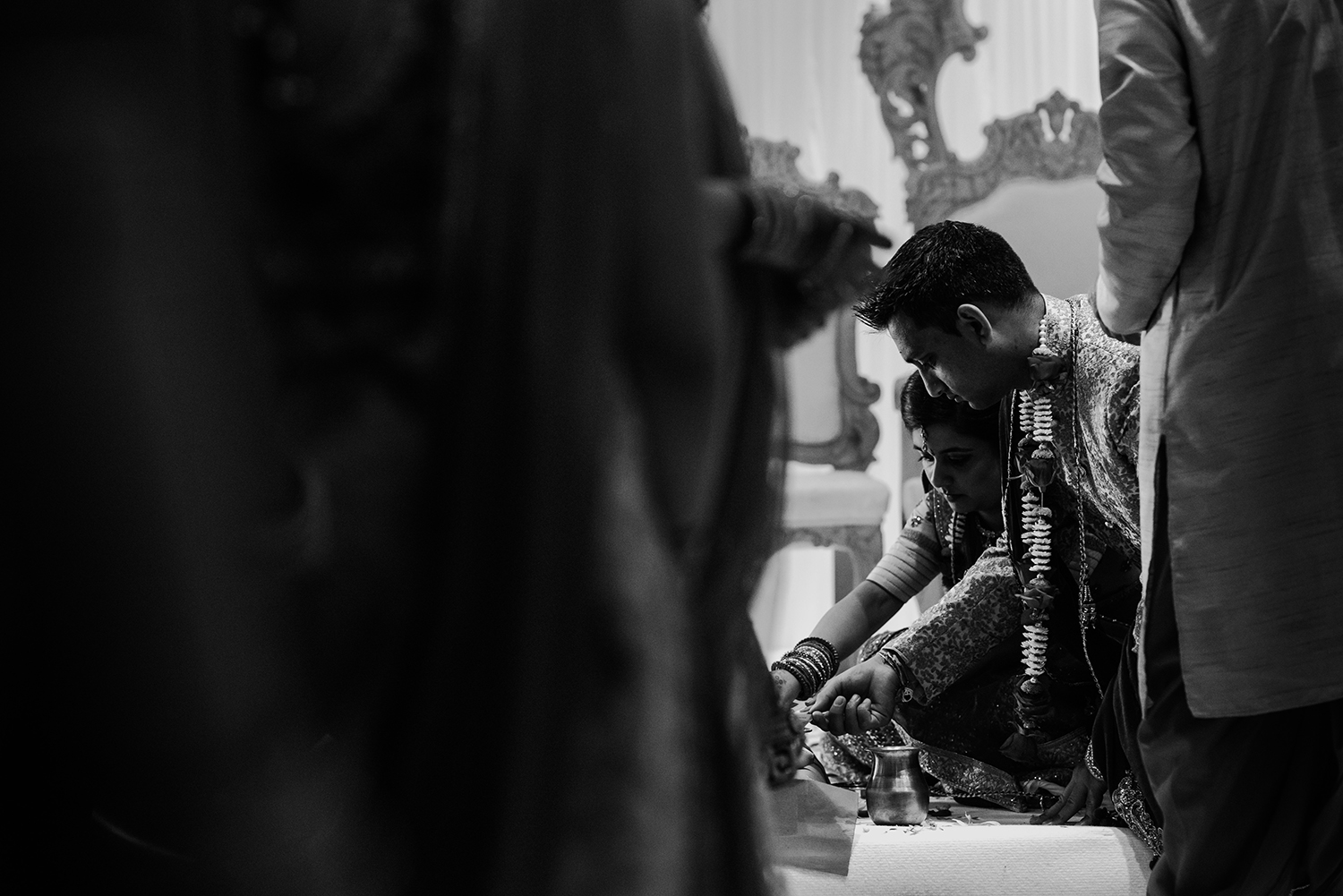  bw photo of bride and groom kneeling and praying 