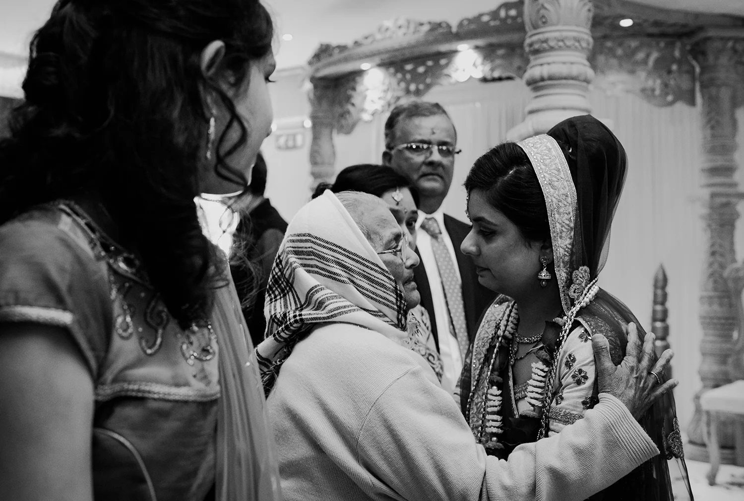 bw photo. Emotional shot of bride saying goodbye to her grandmother