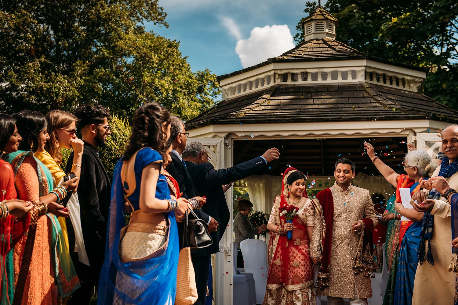 bride and groom leave under confetti