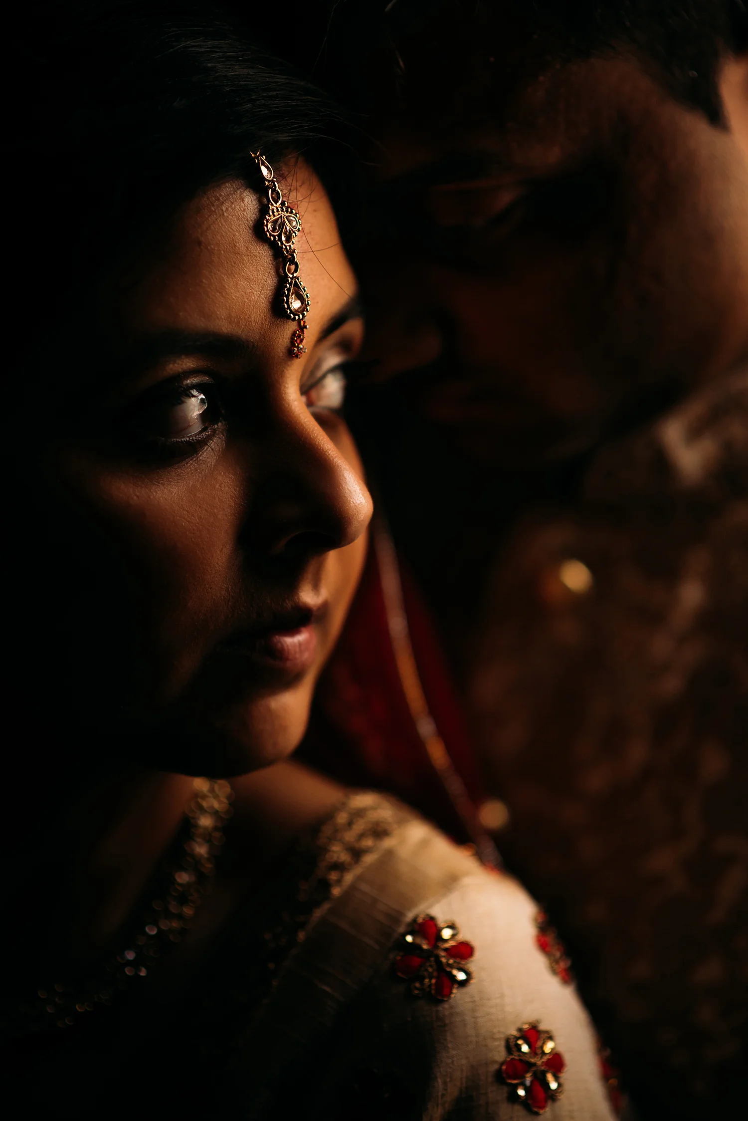 dark photo of bride and groom by brilliant window light