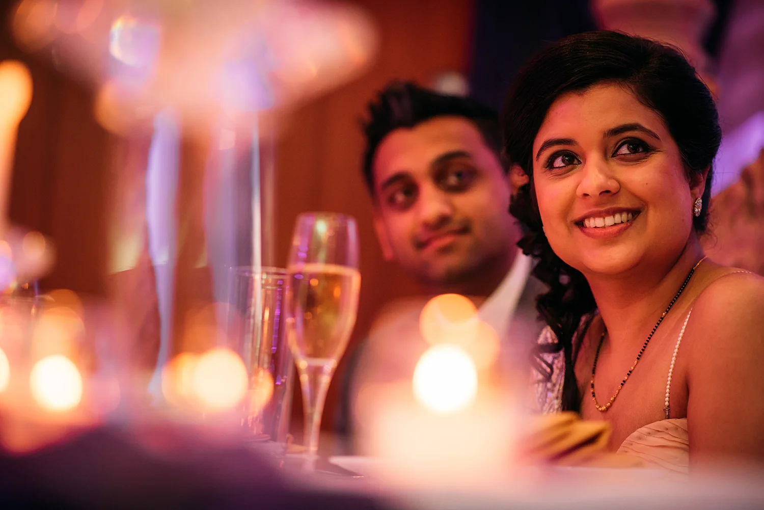 bride and groom listening to speeches
