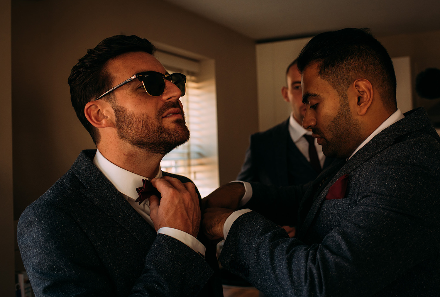  groom adjusting his tie 