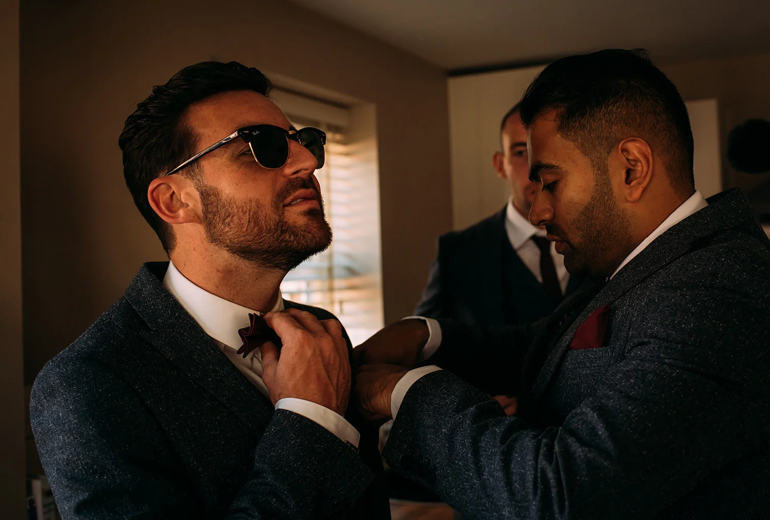 groom adjusting his tie