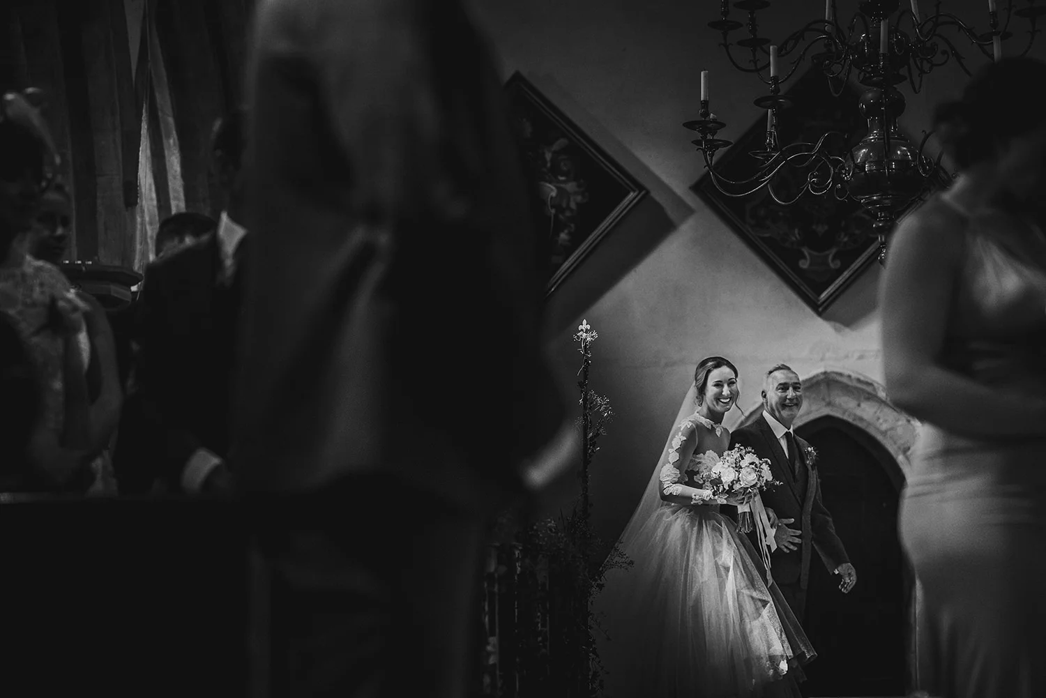 BW photo of the bride entering with her father