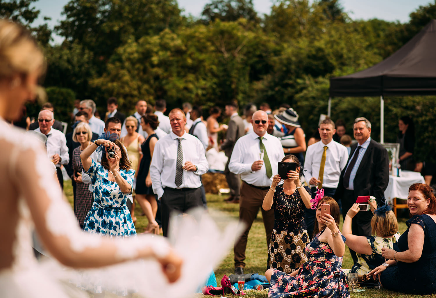  guests photographing the bride 