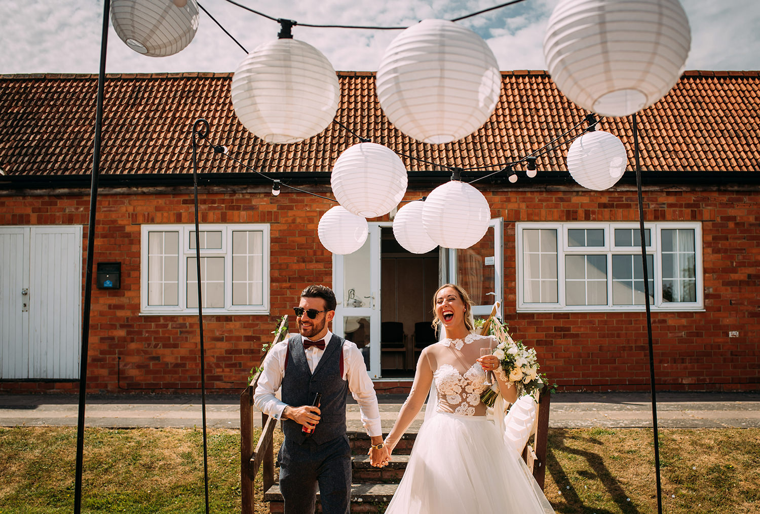  bride and groom enter the reception marquee under lanterns 