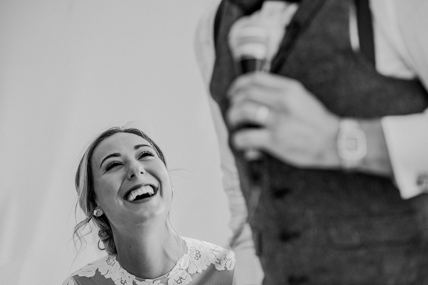  bw photo of the bride laughing at the groom 