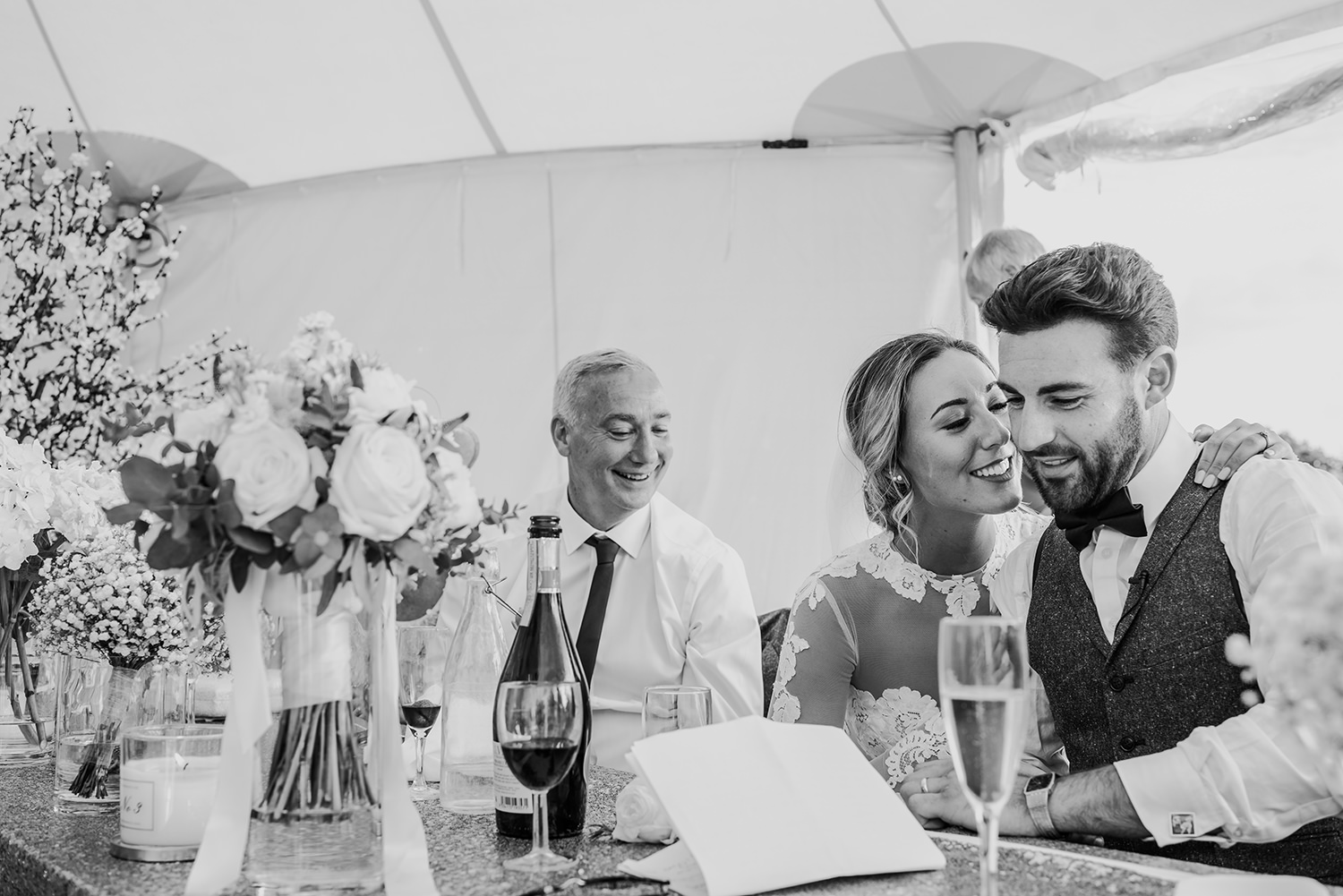  bride kisses the groom after his speech. Bw photo 