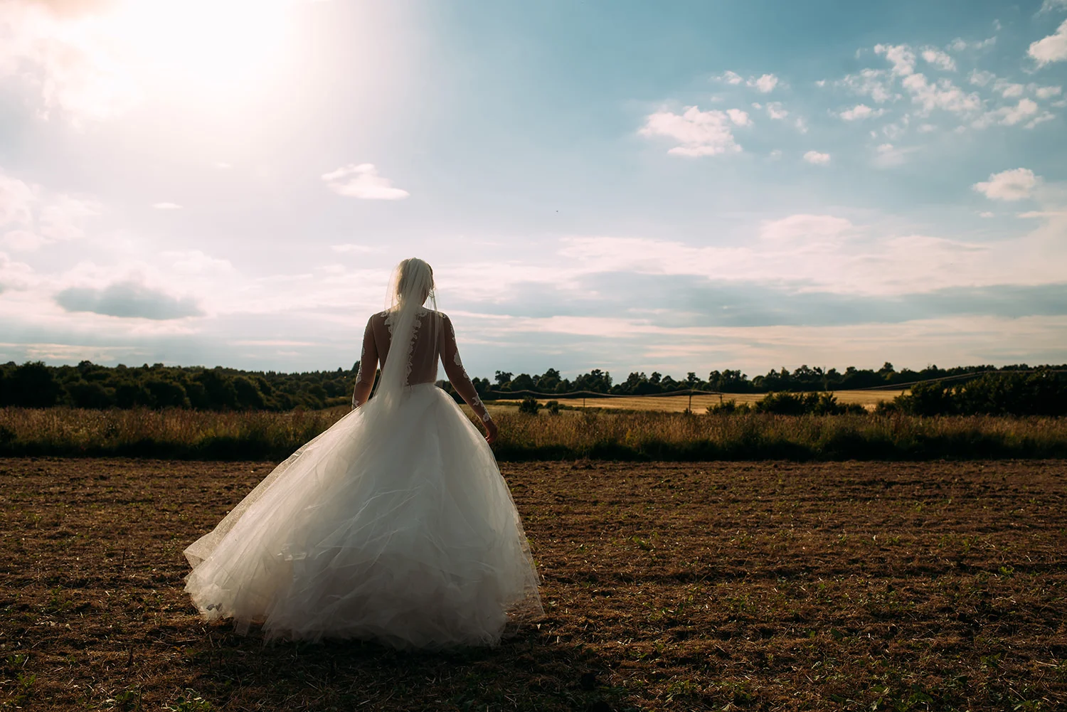 the bride walks into a field
