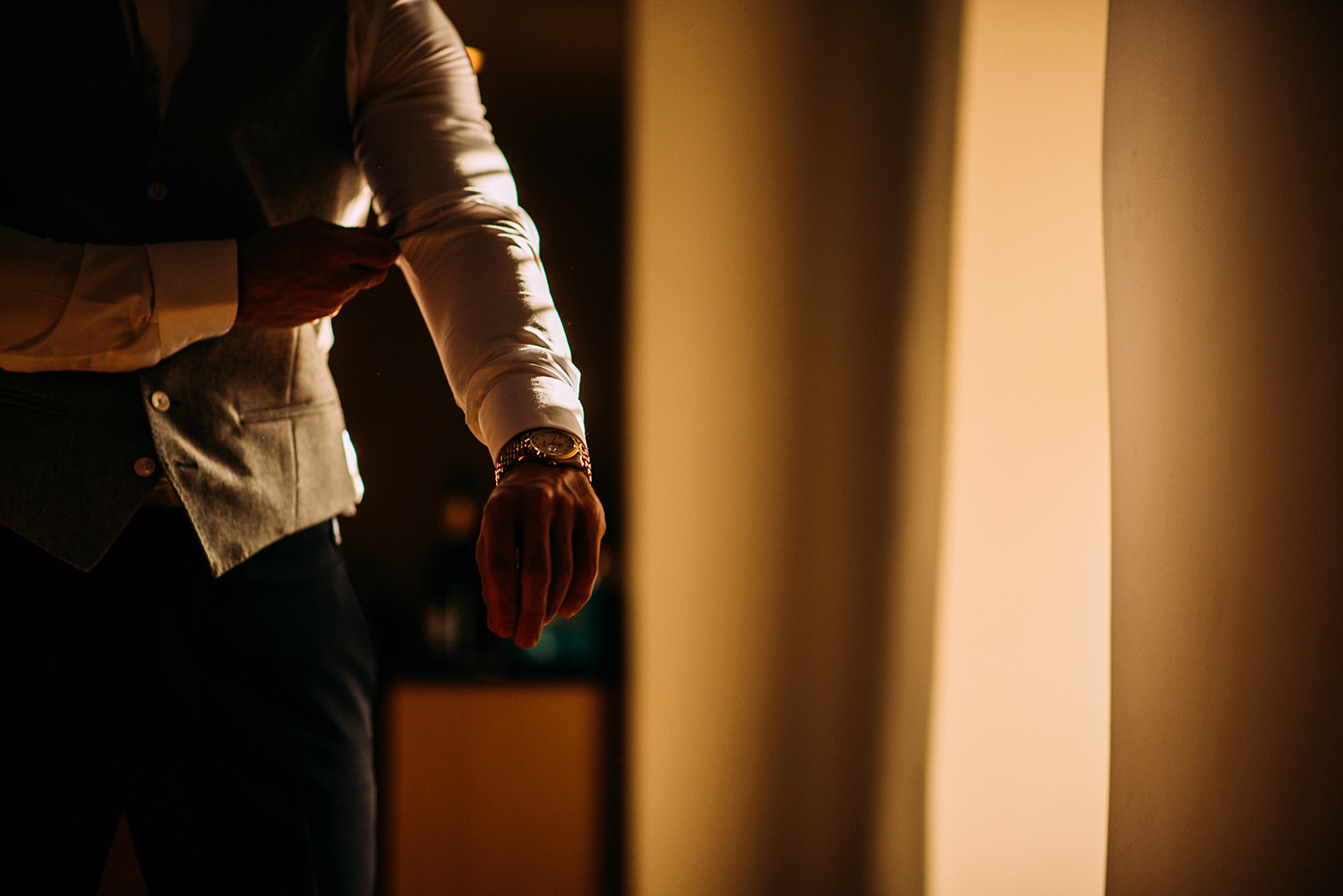 Groom adjusting sleeve in nice light
