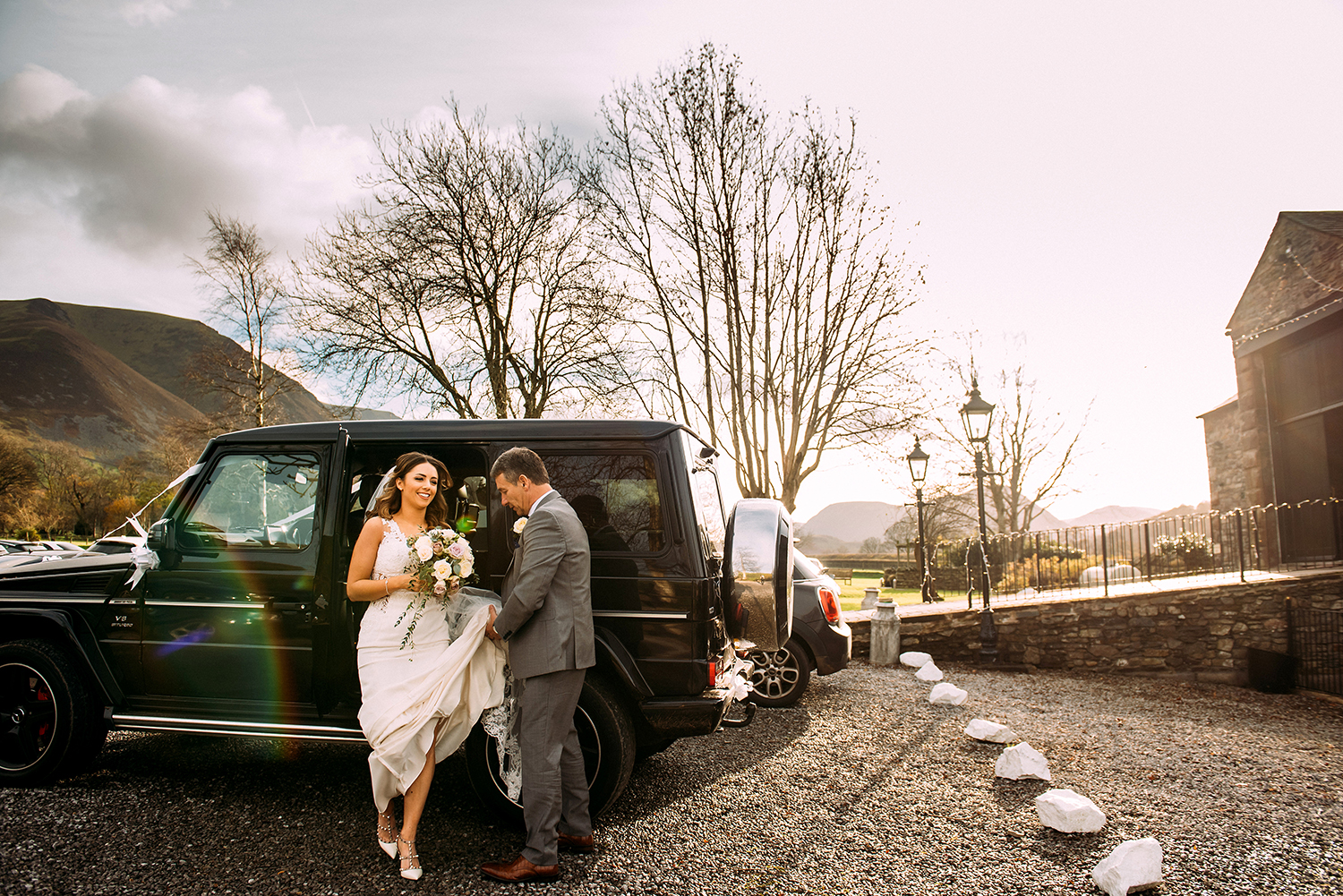 brides father helps her out of the car
