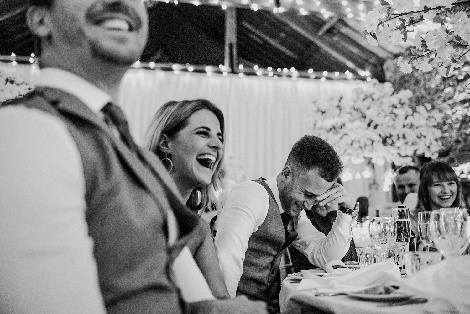 bw photo of guests laughing
