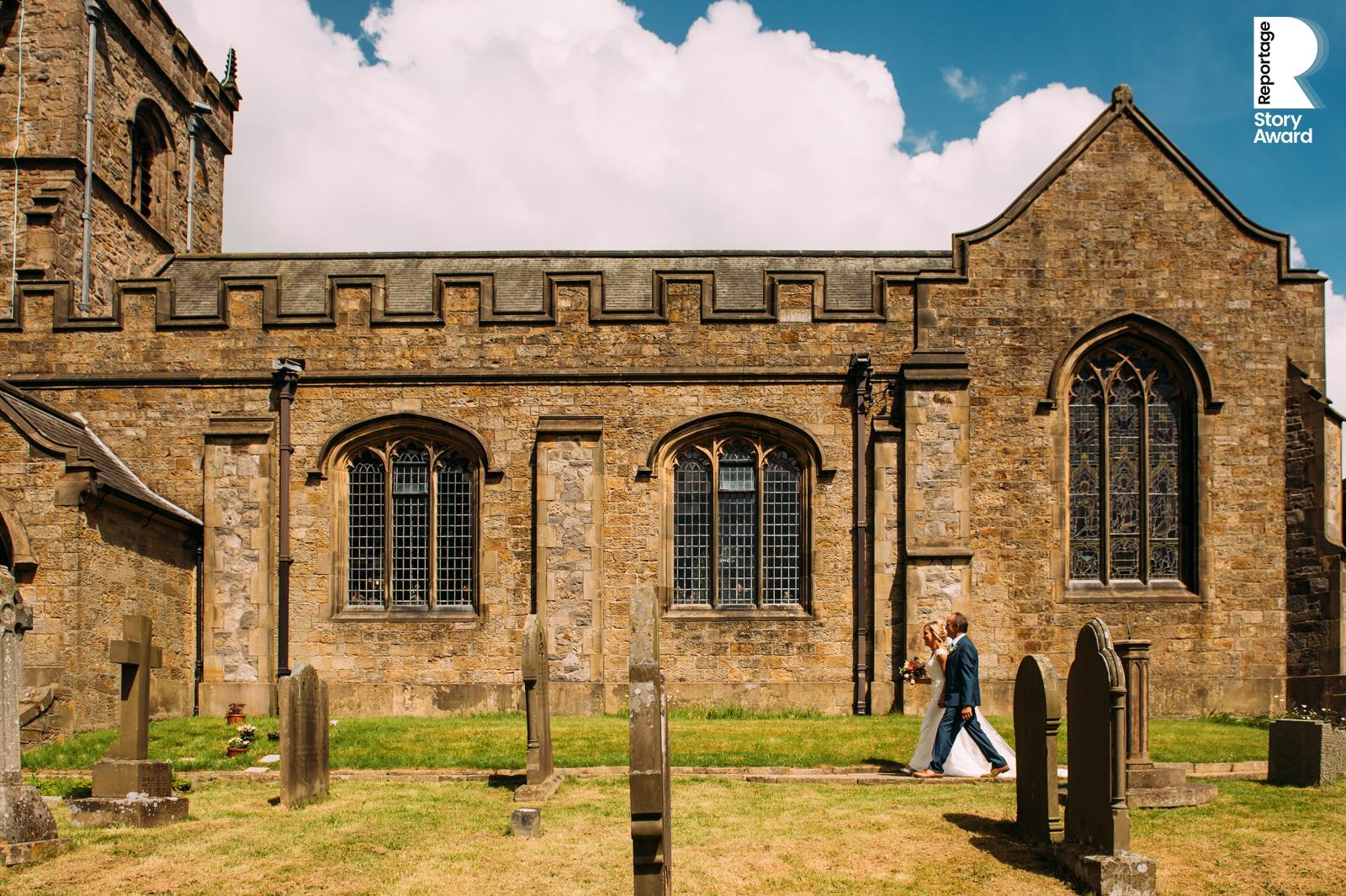 bride and father walking along the church path