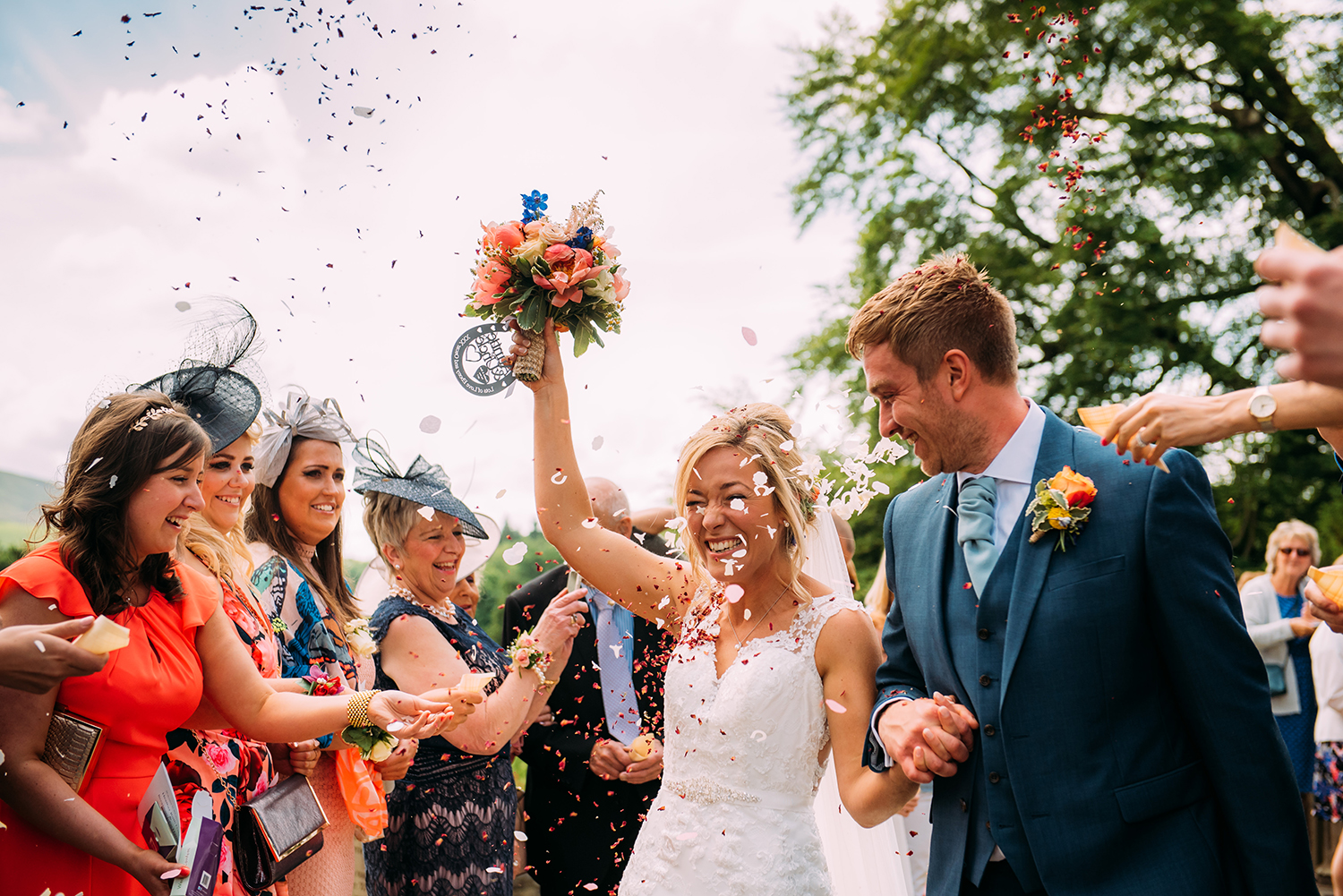couple walk through confetti