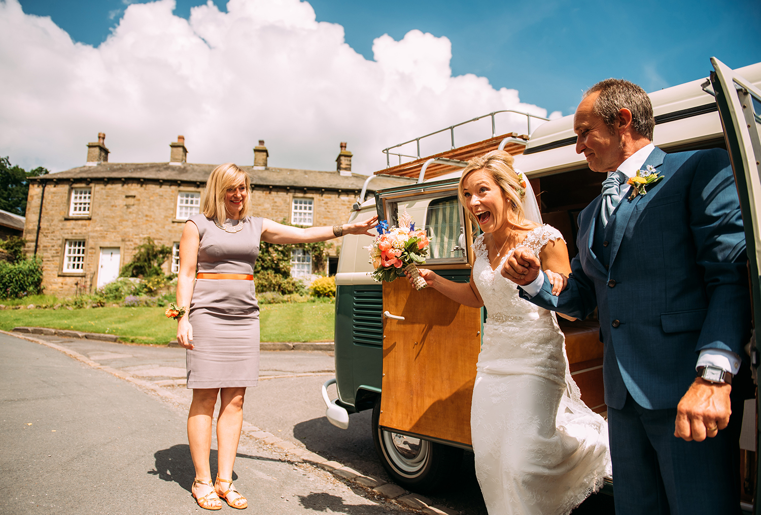 excited bride gets out of the camper helped by her father