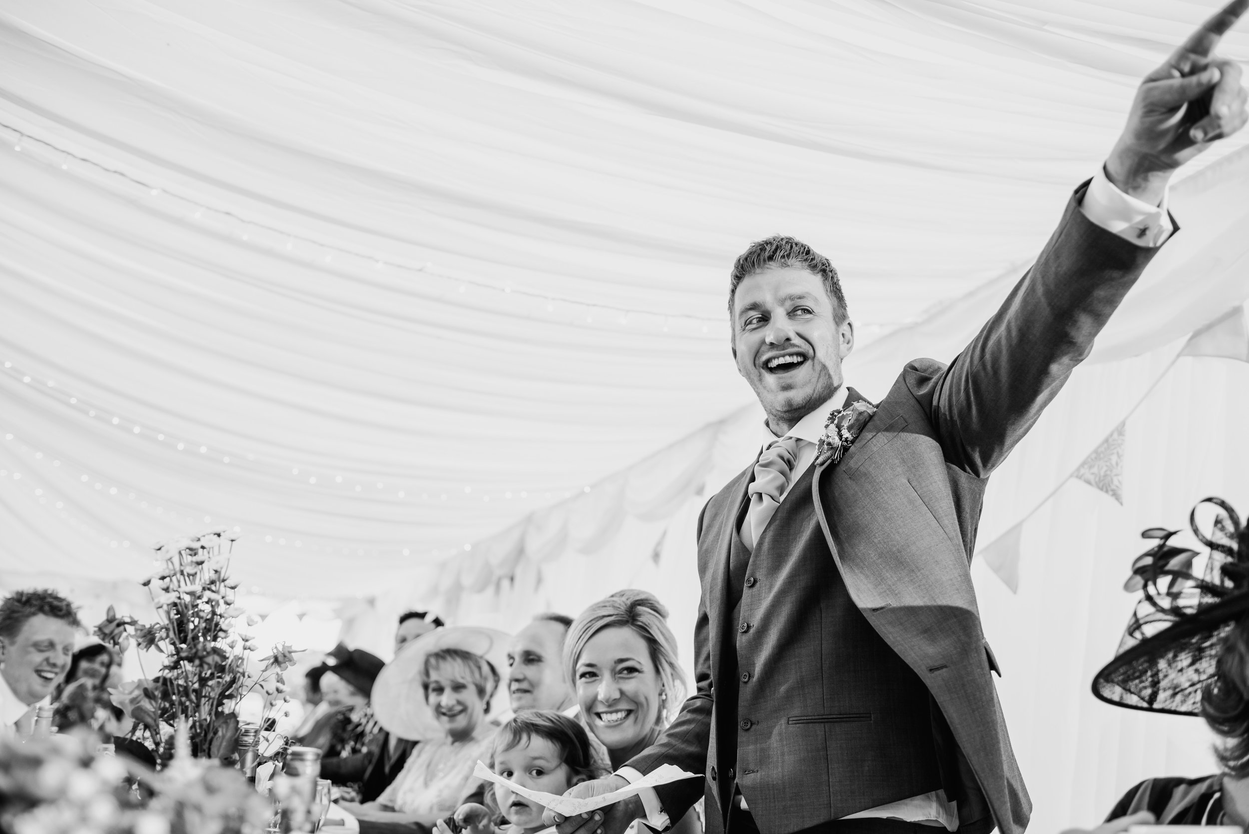 bw photo of the groom pointing