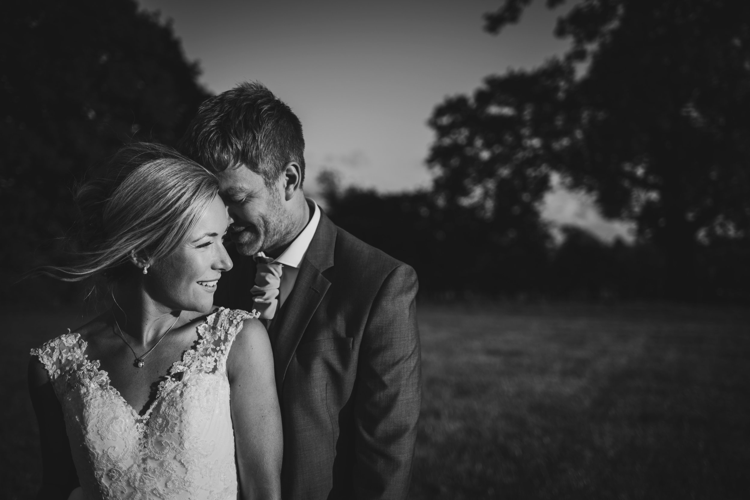 bw photo of the couple cuddling