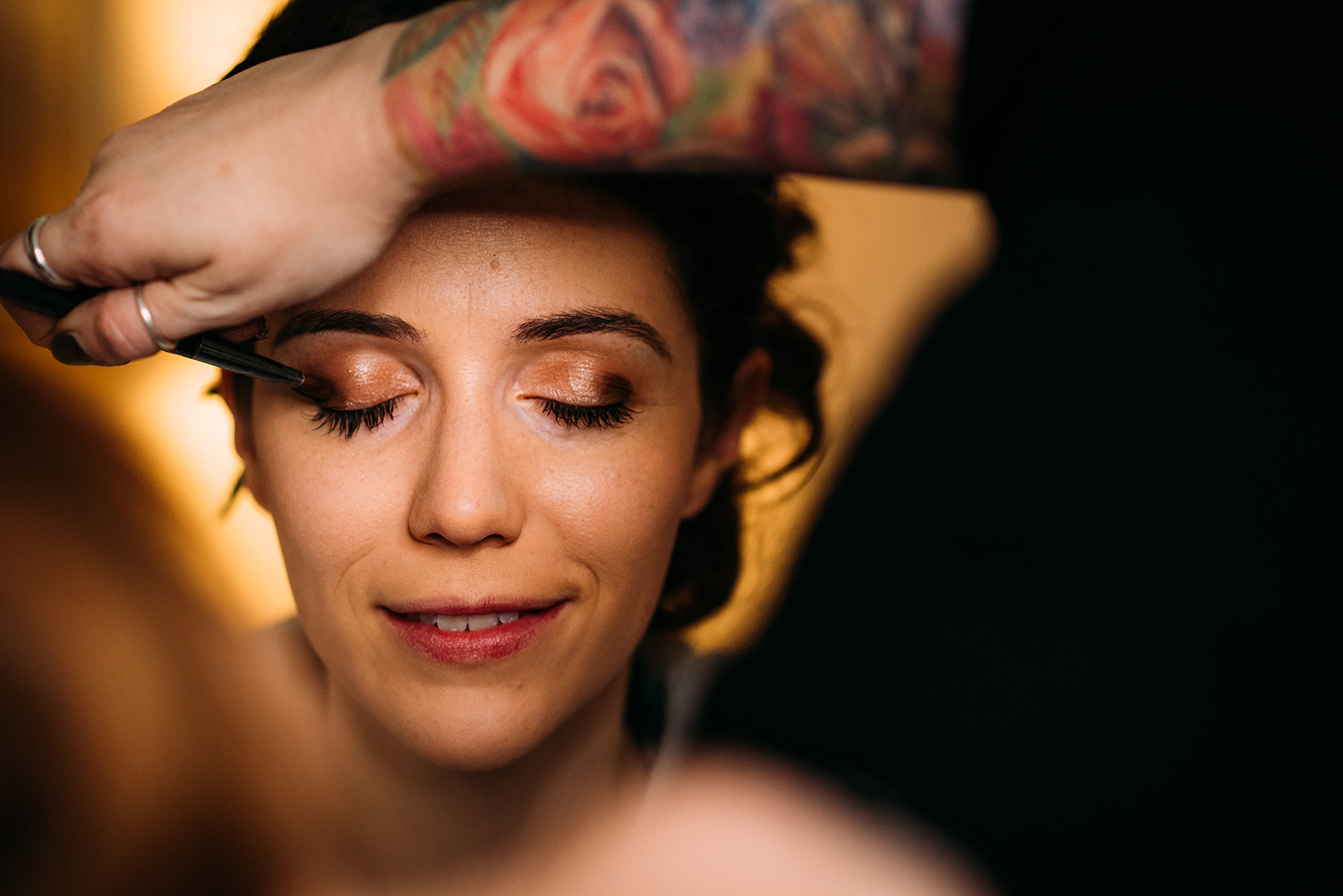 make up shot framed by a tattooed arm