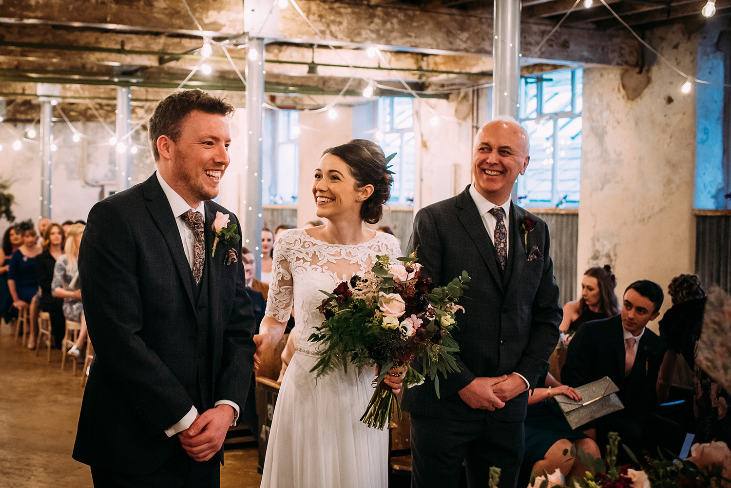 bride and father smiling at the groom