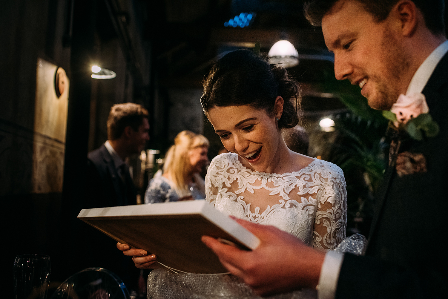 bride and groom looking at a gift they have just received