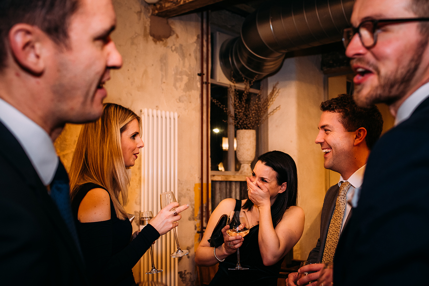 layered shot of guests laughing