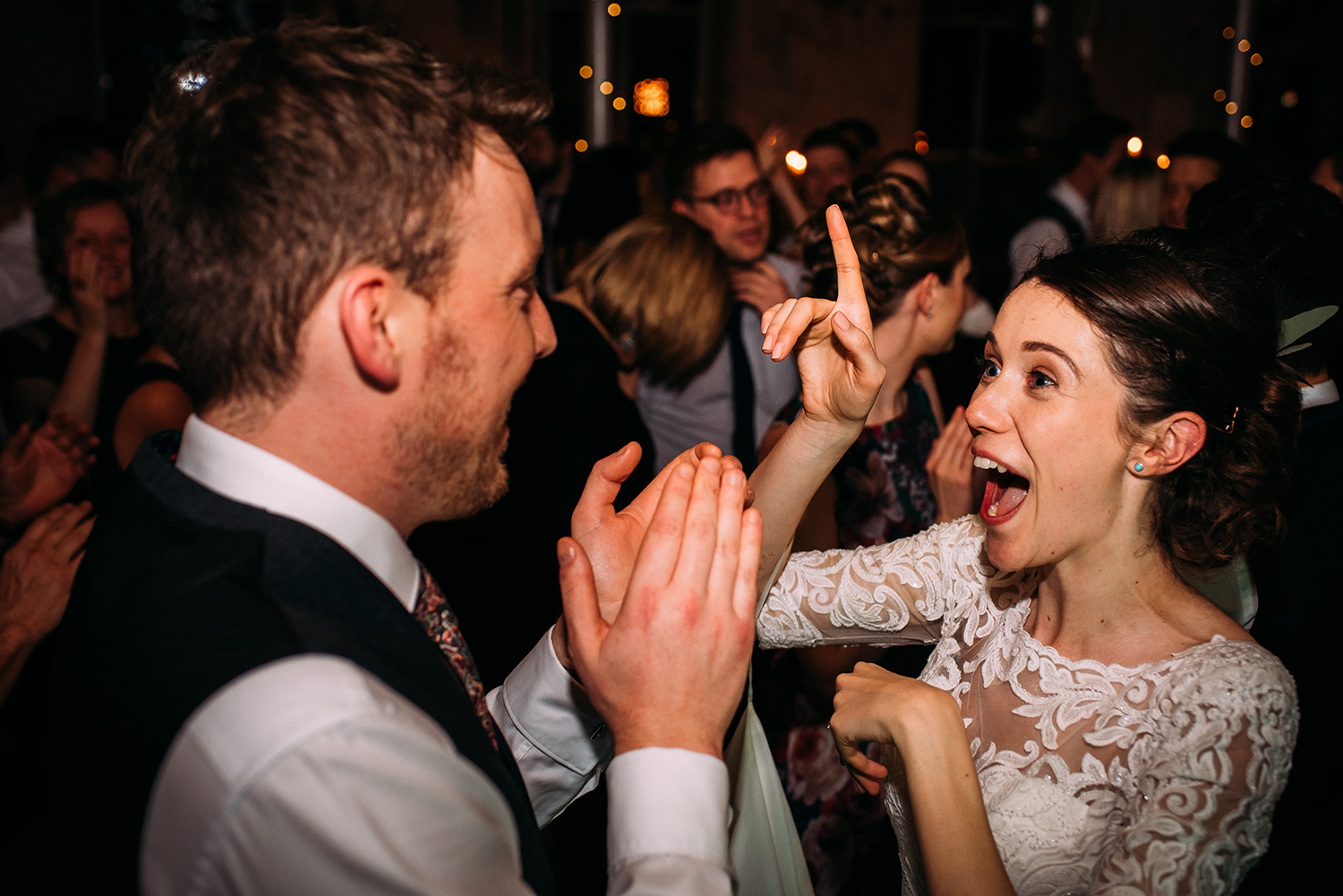 bride and groom dancing among the guests