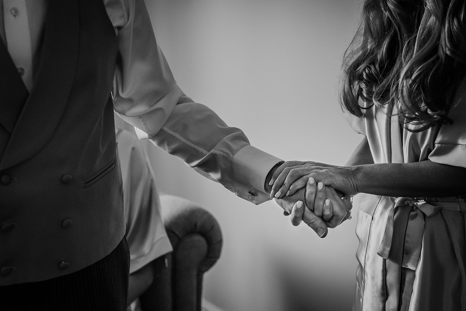 BW photo of bride and her dad holding hands