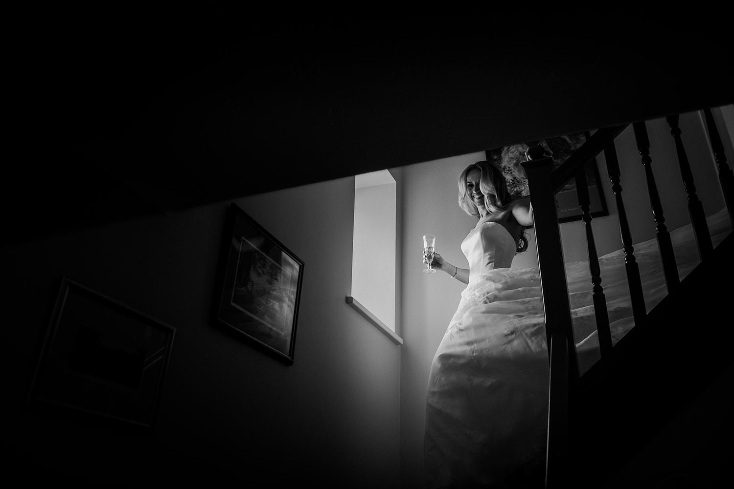 BW photo of bride coming down the stairs
